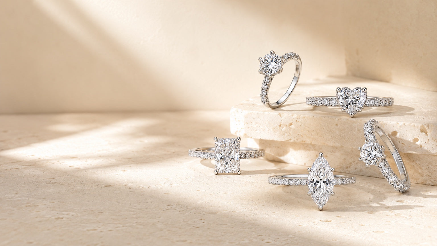 ÉVARIS moissanite rings arranged on warm ivory stone